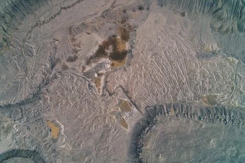 Abstract cracked grey ground texture with dry industrial mud, desolate lunar Stock Photos