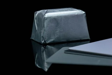 Abstract, creative photo of rectangular shaped candy in shiny packaging Stock Photos