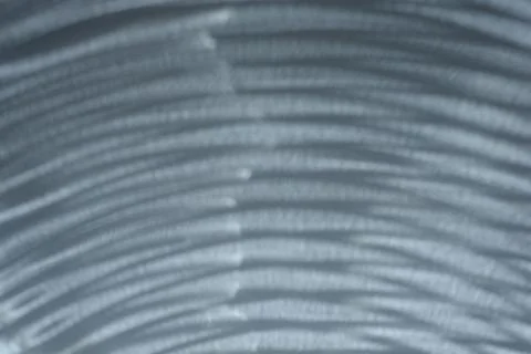 Abstract curved light shadows on gray surface Stock Photos