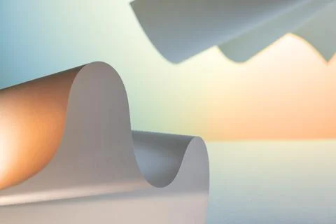 Abstract curved paper forms on soft pastel background with copy space for m.. Foto stock
