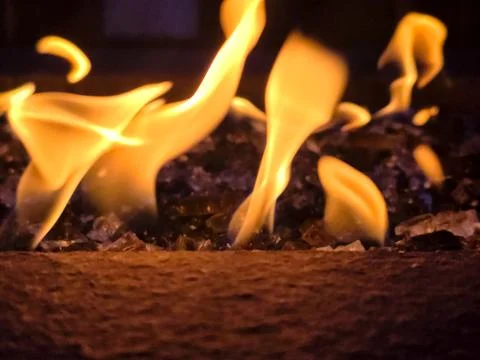 Abstract Dancing Fire Flames Over Decorative Fire Glass in Modern Gas Firep.. Stock Photos