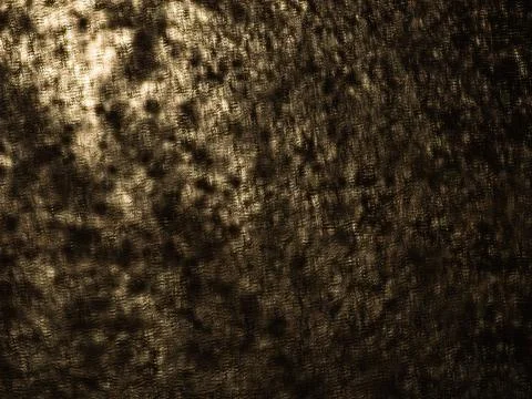 Abstract Dappled Light and Shadow Pattern in Warm Dark Tones Stock Photos