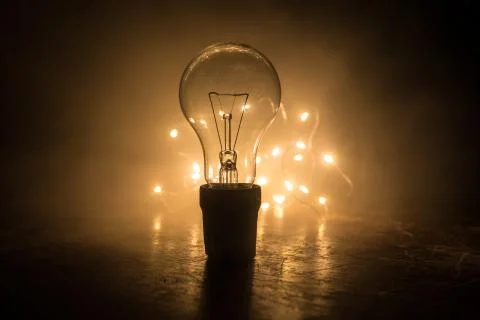 Abstract dark background with creative artwork decoration of glowing bulbs. Stock Photos