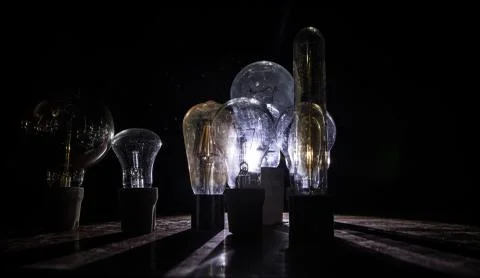 Abstract dark background with creative artwork decoration of glowing bulbs. Stock Photos