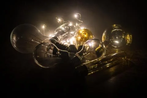 Abstract dark background with creative artwork decoration of glowing bulbs. Stock Photos