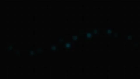 Abstract dark background with faint glowing blue circular bokeh light spots Stock Footage 339618297