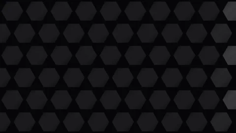 Abstract dark background featuring a repeating pattern of grey hexagons 스톡 동영상 338310873