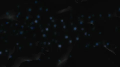 Abstract dark background featuring subtle floating blue light orbs moving in sof Stock Footage 344620657