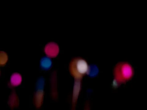 Abstract dark background with soft, out-of-focus vibrant, bright bokeh orbs.. Stock Photos