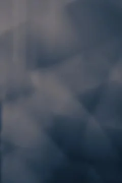 Abstract dark blue background with diagonal lines and bokeh effect. Stock Photos