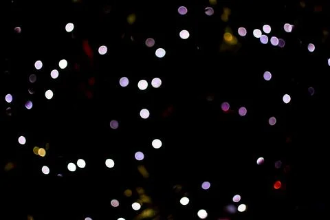 Abstract dark bokeh background with multicolored lights Stock Photos