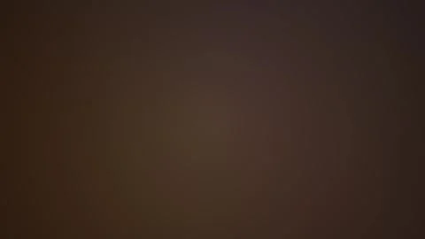 Abstract dark brown pixelated radial gradient background with subtle warm l.. Stock Footage 346321320