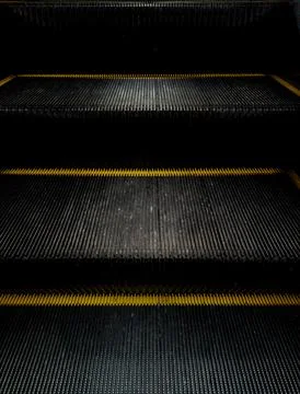 Abstract dark geometric line pattern of escalator steps. Stock Photos