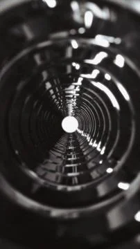 Abstract dark metallic circular tunnel with glowing end Stock Illustration