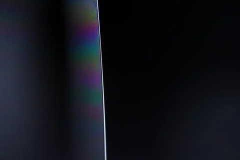 Abstract Dark Surreal Macro of Sharp Edge with Iridescent Rainbow Light Stock Photos