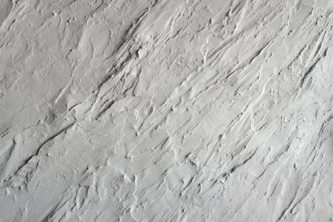 Abstract decorative plaster texture wall with irregular surface and relief Foto stock