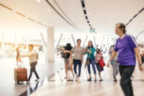 Abstract defocused background of passengers walking in modern airport Stock Photos