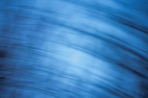 Abstract defocused backplate features deep blues, shadowy gradients, and gl.. Stock Photos