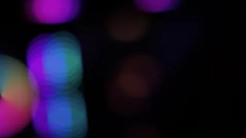 Abstract defocused bokeh lights in purple, pink, blue and green on dark bac.. Stock-Footage 334285784
