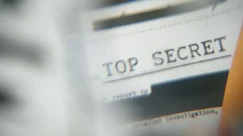 Abstract defocused close up with magnifying glass on Top Secret labeled on file Stock Footage 304281653