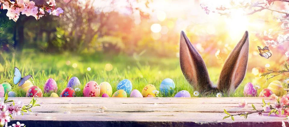 Abstract Defocused Easter Table - Ears Bunny Behind Grass And Decorated Eggs Stock Photos