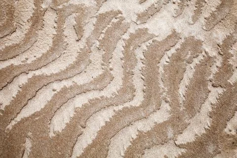 Abstract designs pattern of wet coastal sand Stock Photos