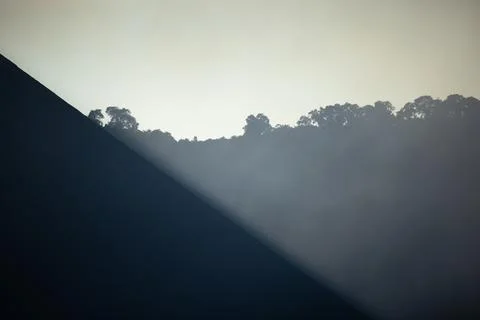 Abstract Diagonal of Ash Slope and Fog under Pale Sky Stock Photos
