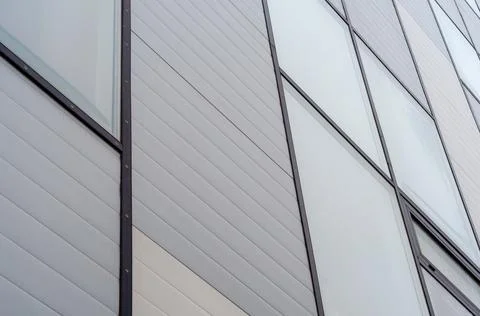 Abstract diagonal building facade with windows and siding background Stock Photos
