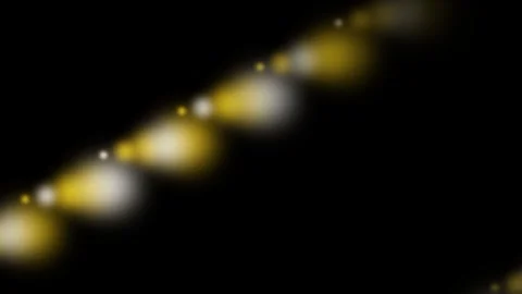 Abstract diagonal line of glowing golden and white bokeh lights on black Video stock 335118097