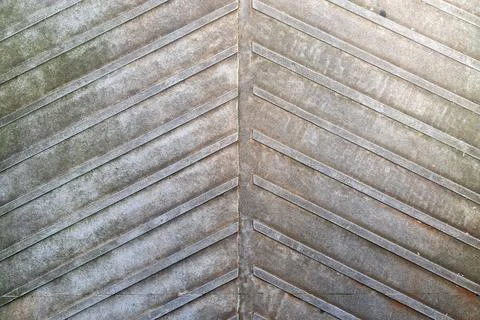 Abstract diagonal pattern with weathered chevron lines on concrete surface Stock Photos