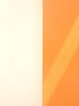 Abstract diagonal shadow on white and orange cement wall Stock Photos