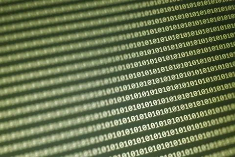 Abstract digital background featuring a matrix of binary code in green tones. Stock Photos