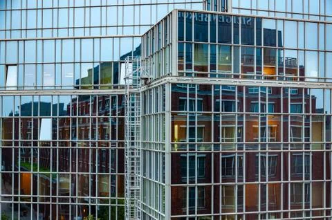 Abstract distorted reflection of house in mirrored glass wall of modern corpo Stock Photos