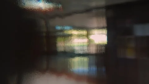 Abstract distorted view through textured glass wall with diffused natural l.. Video stock 314607410