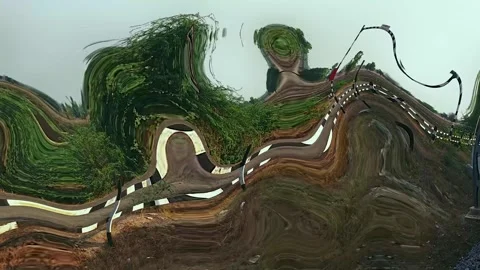 Abstract distorted view of a winding road through lush green vegetation, ca.. Stock Footage 341352100