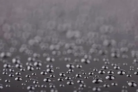 Abstract drops on a black background closeup Stock Photos