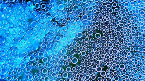 Abstract drops on the surface of transparent plastic. Smooth small bubbles .. Stock Photos