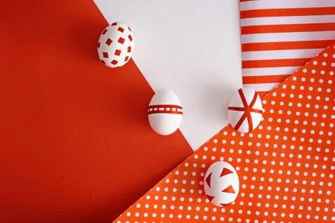 Abstract Easter eggs with red geometric patterns on red and white art backgro Stock Photos