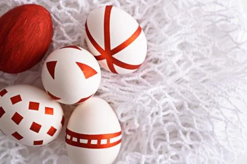 Abstract Easter eggs with red geometric patterns on white mesh eco bag Stock Photos