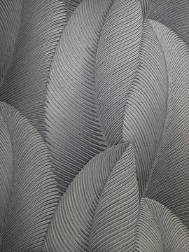 An abstract embossed wallpaper design featuring large overlapping feather-li Stock Photos