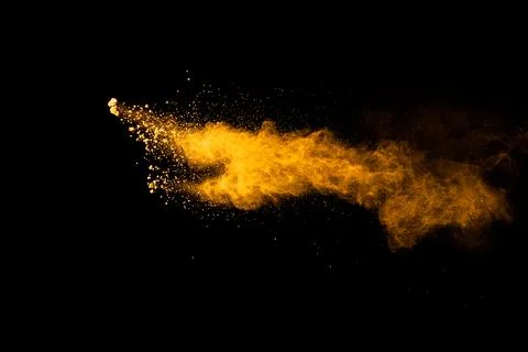 Abstract explosion of orange dust on black background.Freeze motion of oran.. Stock Photos