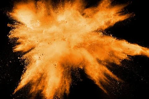 Abstract explosion of orange dust on white background. Freeze motion of ora.. Stock Photos