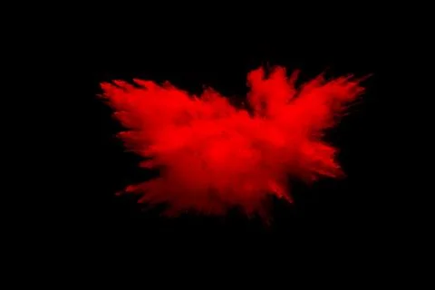 Abstract explosion of red dust  on  black background. Foto stock
