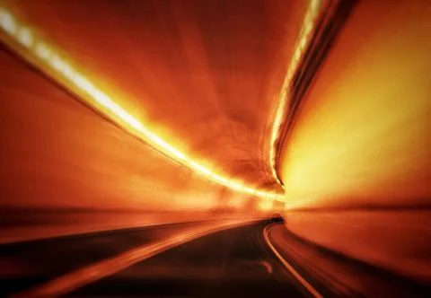 Abstract of fast moving drive through a mountain highway tunnel. Stock Photos