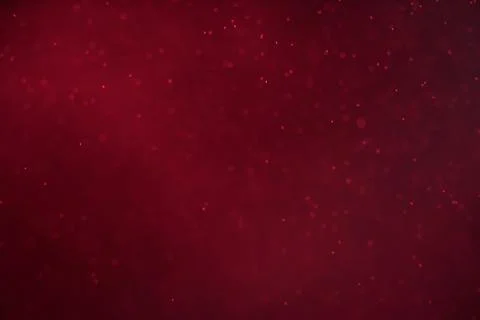 Abstract festive background with selective focus. Bright particles on dark red Illustrazione stock