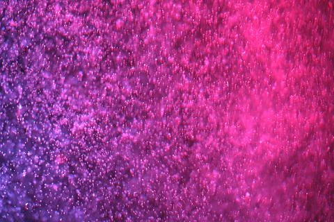 Abstract festive background with selective focus. Bright red-purple particles Illustrazione stock