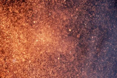 Abstract festive background with selective focus. Bright yellow particles, dark Stock Illustration