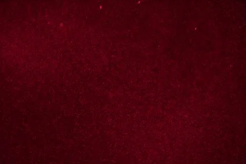 Abstract festive background with selective focus. Bright particles on dark red Stock Illustration