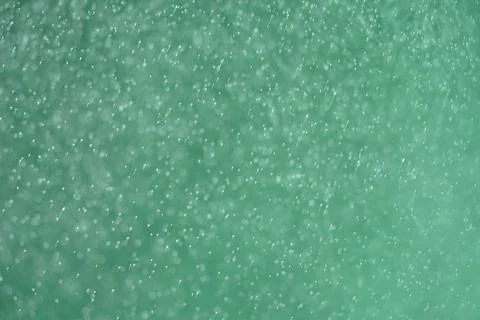 Abstract festive background with selective focus. Bright particles on green Stock-Illustration