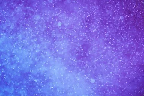 Abstract festive background, selective focus. Bright particles on blue-purple Stock-Illustration